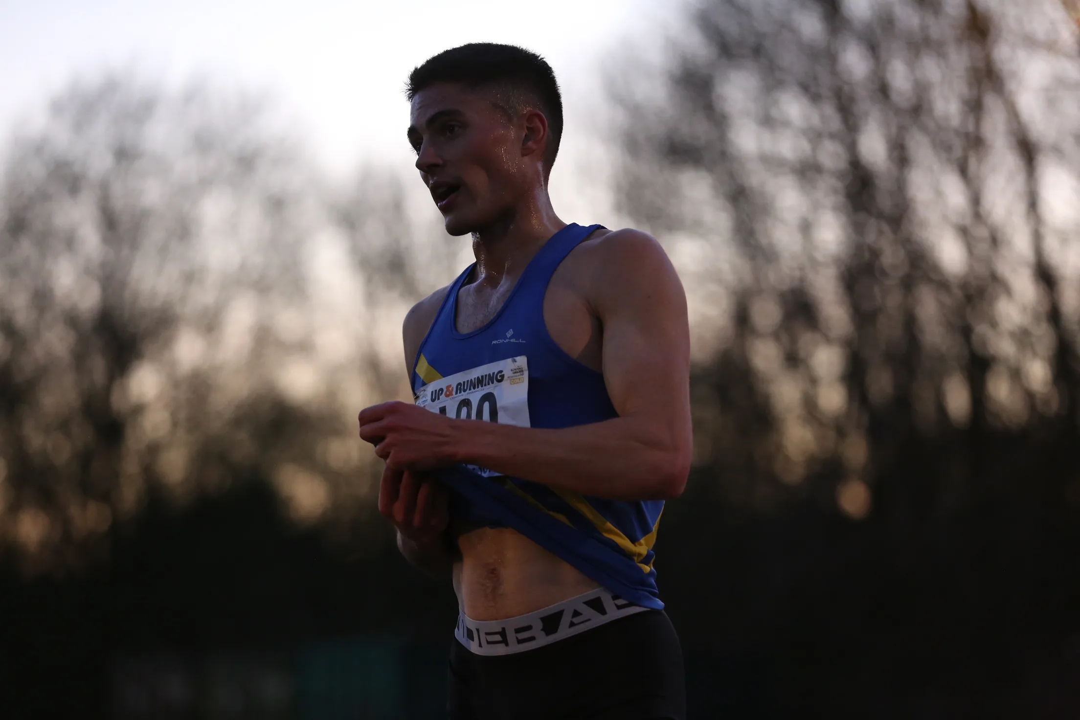 Runner catching his breath at dusk after a race